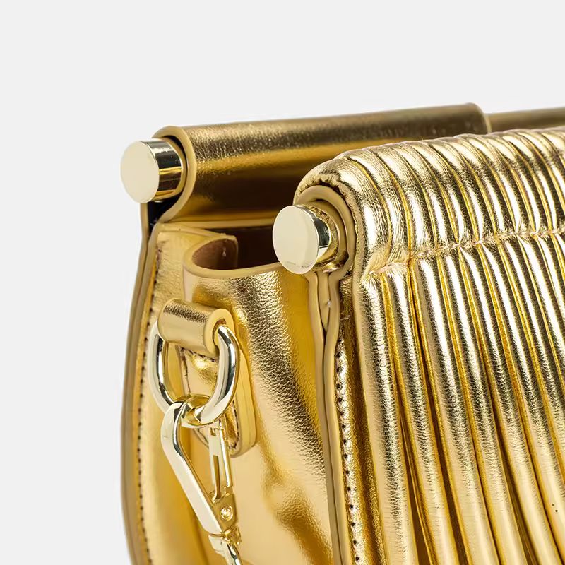 Luxury gold fan-shaped clutch bag Ventaglio d’Oro – structured metallic designer handbag with sculptural design.
