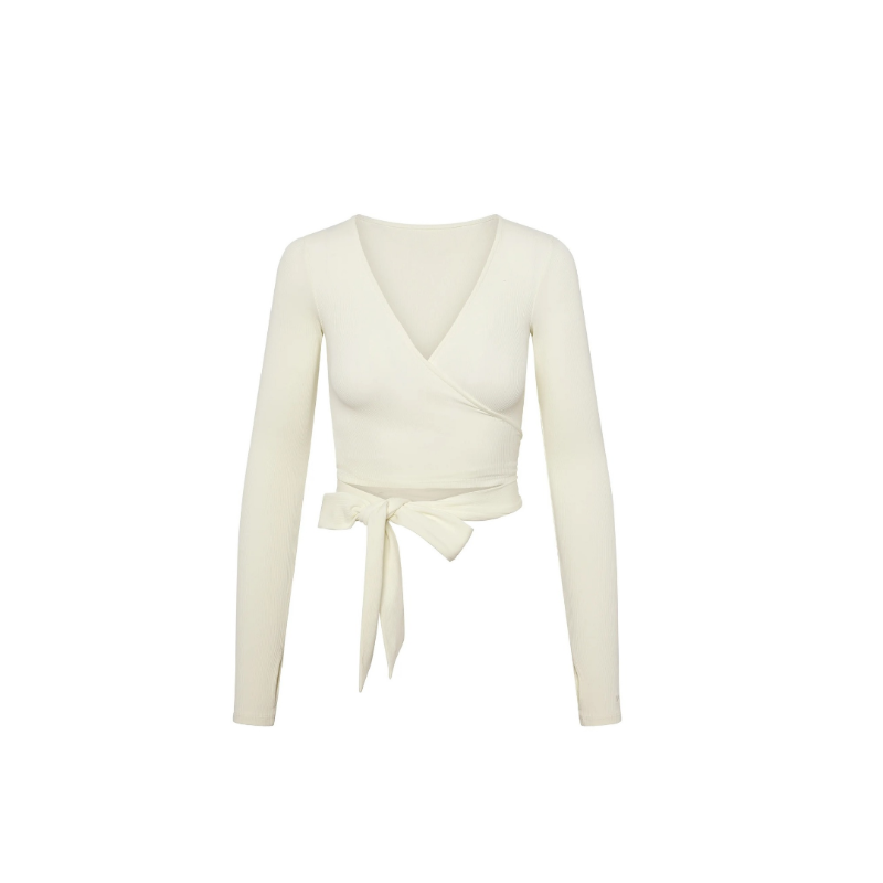 Minimalist women’s sculpted wrap top – ribbed texture, feminine fit, neutral tones – everyday luxury outfit.