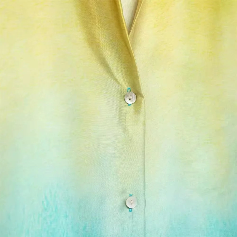 Two-piece ombre outfit with yellow to blue gradient – button-up shirt with collar and high-waisted wide-leg pants in soft polyester.