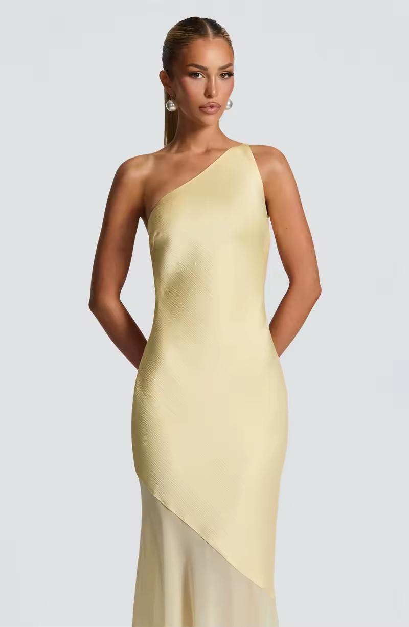 Elegant yellow evening gown with tie-back detail and sheer hem – perfect for weddings and summer parties