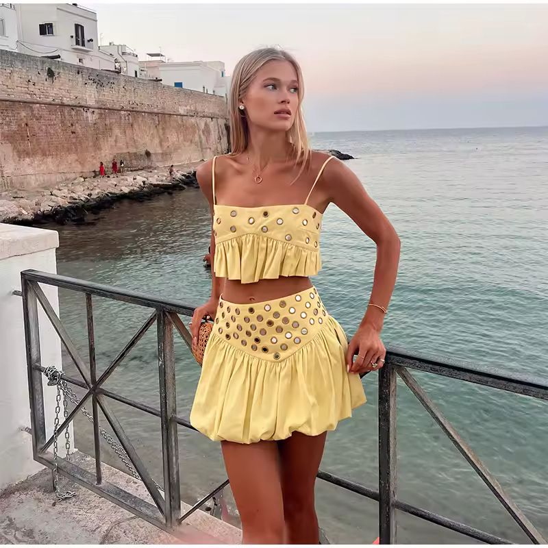 Yellow ZAYA outfit featuring a spaghetti strap crop top and A-line skirt with metallic eyelets