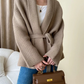 Model wearing an oversized cardigan in warm gray, showcasing its relaxed fit and cozy style.