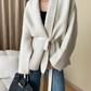 Model wearing an oversized cardigan in warm gray, showcasing its relaxed fit and cozy style. Chic and Charm