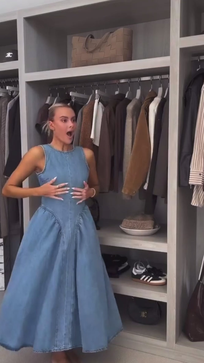 Woman wearing sleeveless backless denim dress with O-neckline – summer 2025 fashion trend
