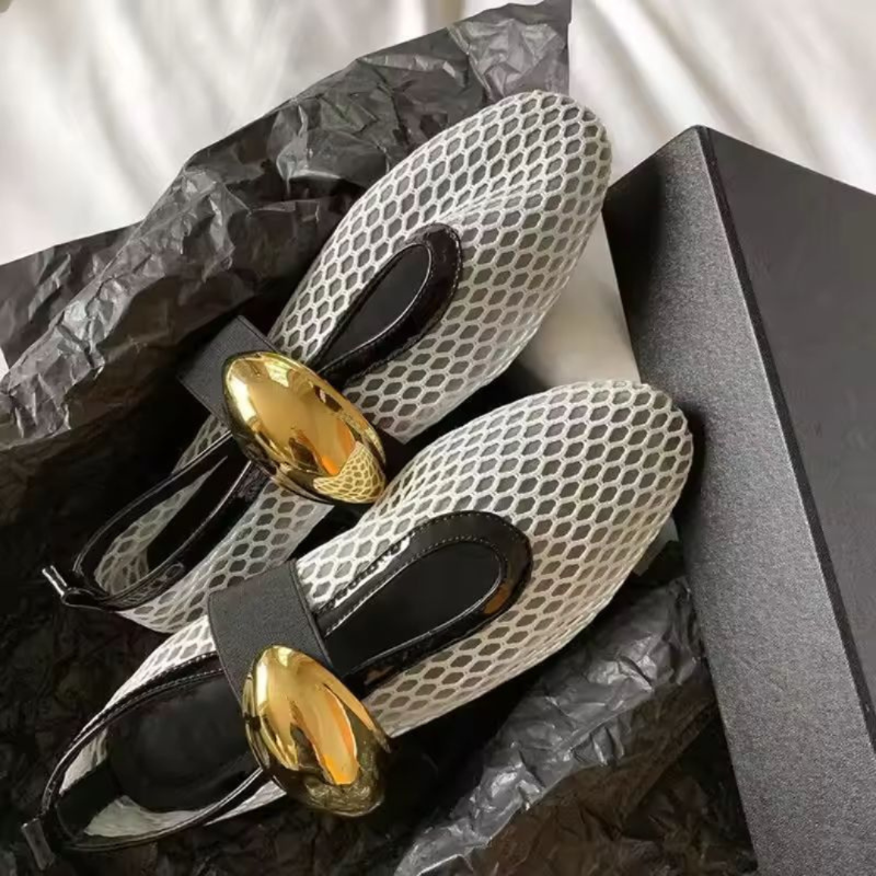 Women’s mesh loafers in white and black with gold accent. Flat, breathable summer shoes with slip-on comfort and stylish luxury detail.