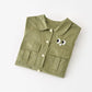 Chic Charm green baby overall with pockets and eye details – soft 100% cotton, hooded, snap button closure, perfect for babies and toddlers.”