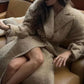 Double-breasted wool coat measuring 38 inches in length, perfect for a stylish layered look.