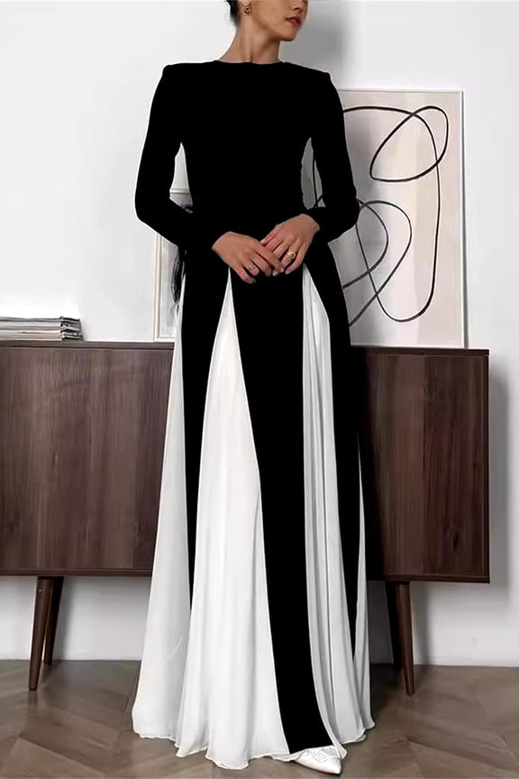 Close-up of the tailored black bodice and flowing white skirt of the dress.