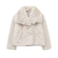 Fashionable white winter jacket with faux fur collar displayed outdoors