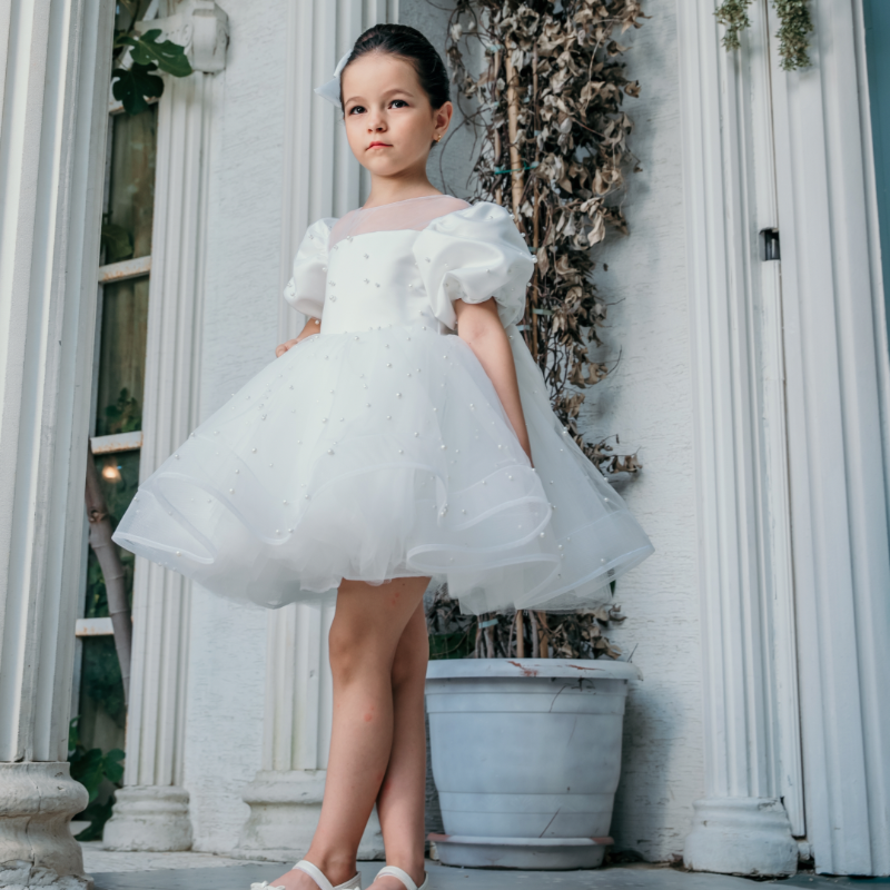 Close-up of delicate embroidered tulle on a luxury flower girl dress with elegant detailing.