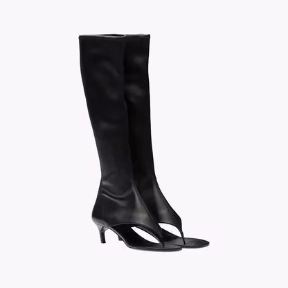Black knee-high stretch sandal boots for women with 7cm kitten heel and open pinch toe, made from vegan PU leather, shown from the side.
