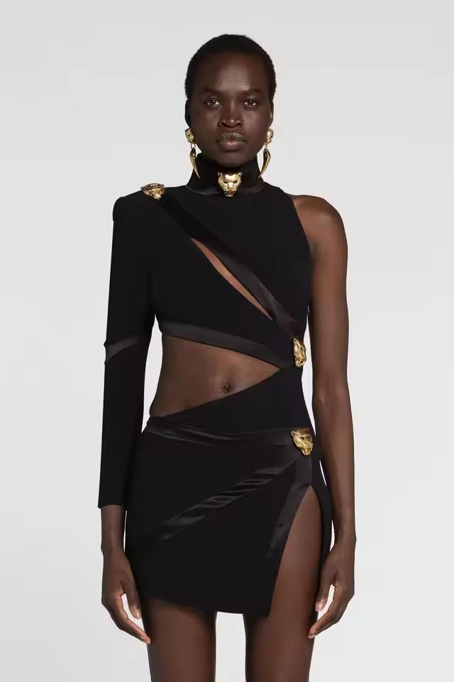 Model wearing The AURA One-Shoulder Cut-Out Mini Dress in black — asymmetric high-neck mini dress with gold accents, bodycon fit, and elegant cut-out design, perfect for evening parties and luxury fashion looks.
