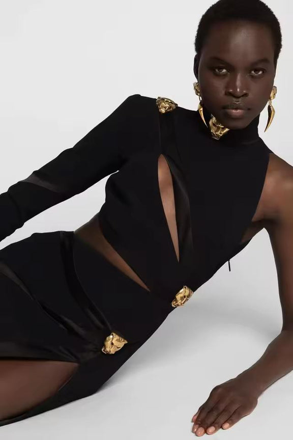 Model wearing The AURA One-Shoulder Cut-Out Mini Dress in black — asymmetric high-neck mini dress with gold accents, bodycon fit, and elegant cut-out design, perfect for evening parties and luxury fashion looks.
