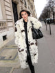 Long white faux fur coat with cow print, stylish women's outerwear, trendy faux fur coat, elegant fashion statement, chic casual coat, sustainable women's fashion, versatile winter coat.