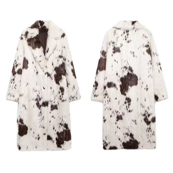 Long white faux fur coat with cow print, stylish women's outerwear, trendy faux fur coat, elegant fashion statement, chic casual coat, sustainable women's fashion, versatile winter coat.