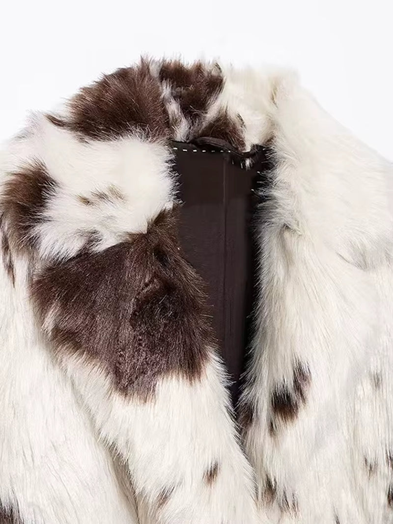 Long white faux fur coat with cow print, stylish women's outerwear, trendy faux fur coat, elegant fashion statement, chic casual coat, sustainable women's fashion, versatile winter coat.
