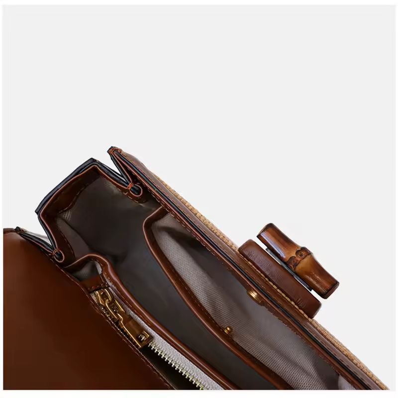 Interior view of Bamboo Grace straw and leather handbag with bamboo handle, showing spacious compartments, hidden coin pocket, phone slot, and zippered section – luxury crossbody bag for women, summer boho purse, eco chic leather bag.
