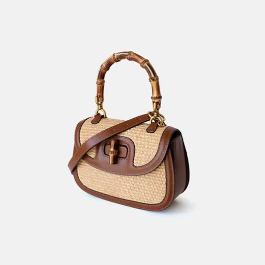Side view of small bamboo handle handbag made from natural straw and genuine cowhide leather, adjustable shoulder strap, high-quality summer handbag for women – perfect everyday purse with boho style and luxury finish.
