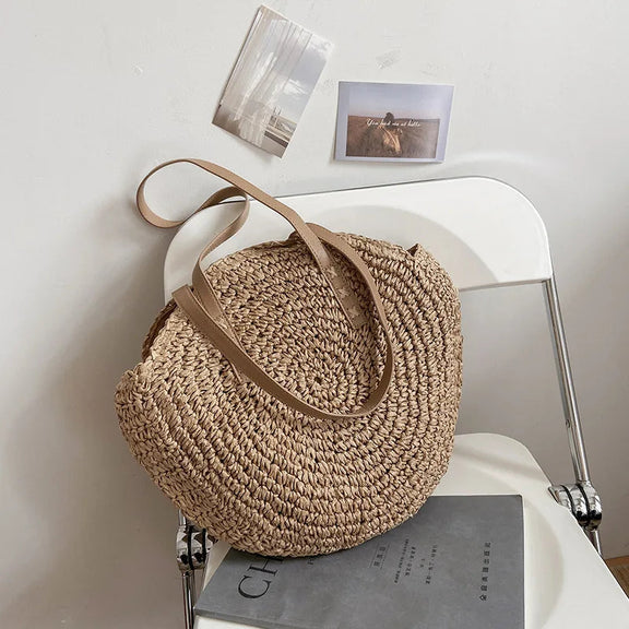 Boho round handbag made of straw with soft lining and long straps
	