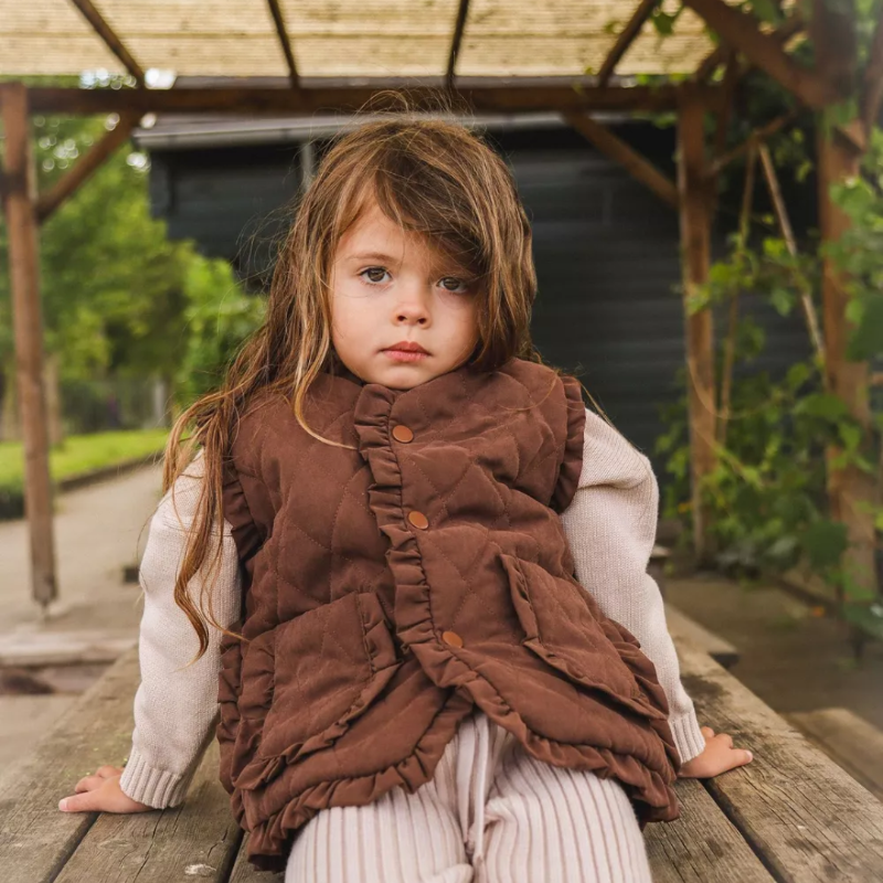 Piper Ruffle Vest for Girls by Chic Charm, stylish beige and brown kids’ vest with ruffle trims, functional front pockets, and snap buttons, made from 95% cotton and 5% polyester for comfort, warmth, and versatility, perfect for layering year-round.