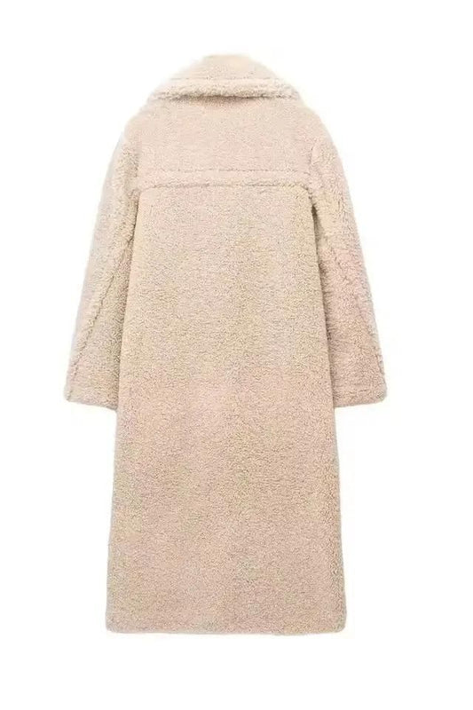 Women's long beige teddy coat – double-breasted faux shearling winter coat with lapel collar and soft lamb fleece texture.

