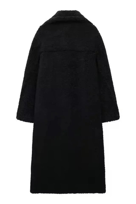 Elegant black long teddy coat for women – thick faux shearling winter coat with double-breasted design and wide lapels.
