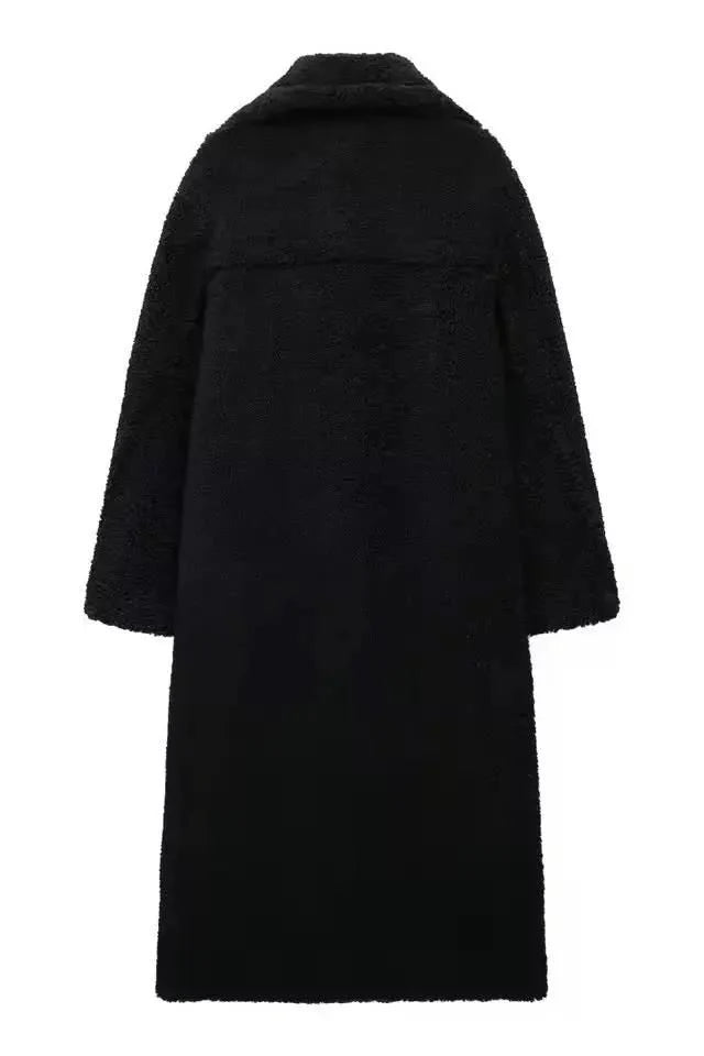 Elegant black long teddy coat for women – thick faux shearling winter coat with double-breasted design and wide lapels.
