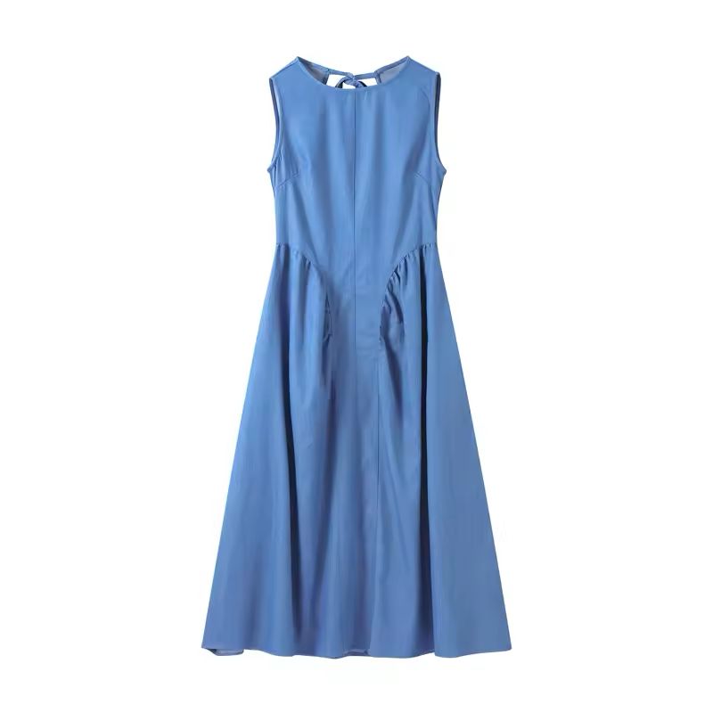 Woman wearing sleeveless backless denim dress with O-neckline – summer 2025 fashion trend

