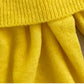 Bright yellow off-shoulder cotton sweater for women, soft and breathable, perfect for spring fashion with a feminine and playful design.