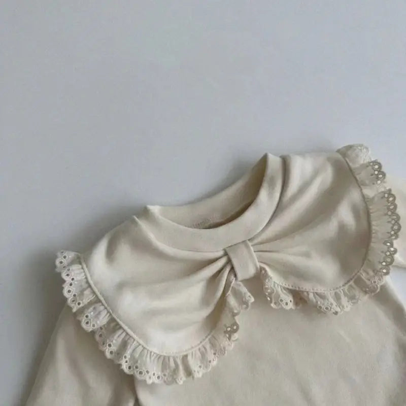 Beige and brown baby tops for girls made from 100% cotton, featuring a decorative bow, lace trims, and floral pattern, perfect for fall fashion and comfortable baby clothing.