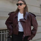 Burgundy vegan leather jacket for women with wide lapel, epaulettes, waist belt, and breathable lining, perfect for sustainable fashion.