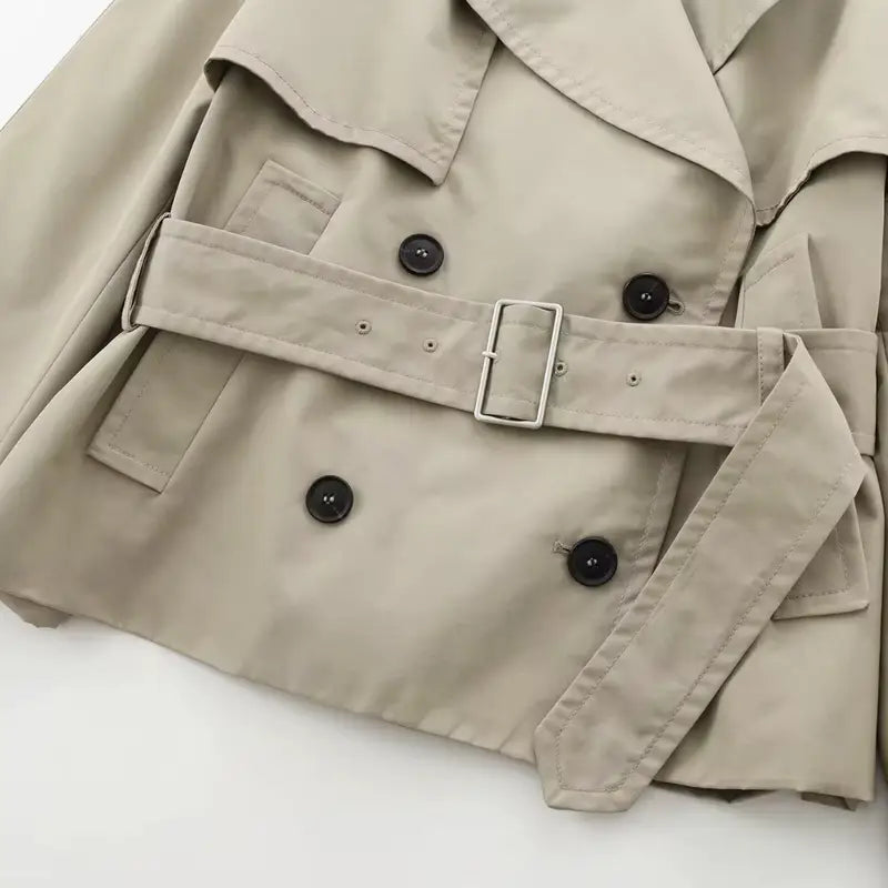 Beige double-breasted coat with black buttons, adjustable belt, and shoulder epaulets, designed for stylish and comfortable wear. Perfect for every occasion, made from high-quality polyester and crafted in Italy.