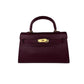 Beauty de Luxe Handbag in chic burgundy, featuring a textured surface and metallic closure