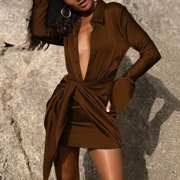 Elegant black satin wrap dress for women with V-neck, lapel collar, ruched waist, and long sleeves – perfect for evening events or parties.

Front view of black satin mini dress with tie waist and pleated detail – luxury clubwear for summer 2025.
