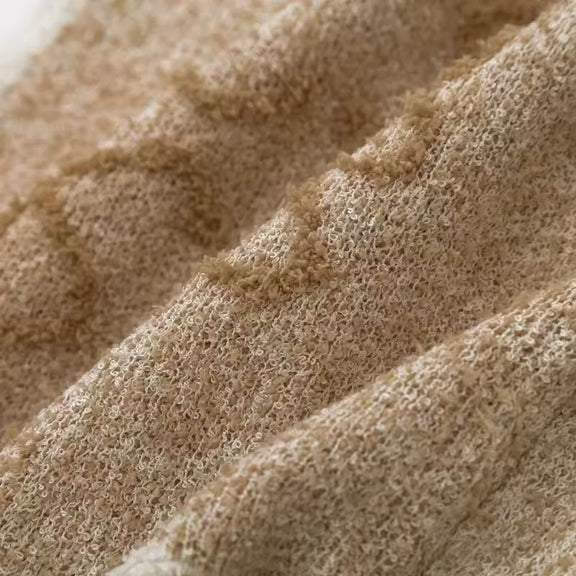 Back view of soft beige cropped knit vest with ribbed hem – minimal sleeveless sweater for women
