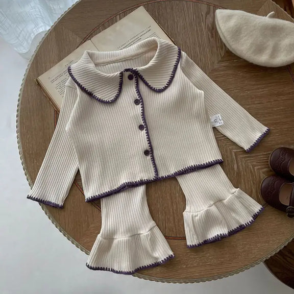 Chic Charm two-piece baby set with ruffles, made from 100% cotton, featuring a button closure and delicate ruffle details on sleeves and hem. Comfortable and stylish baby clothes for everyday wear or special occasions.