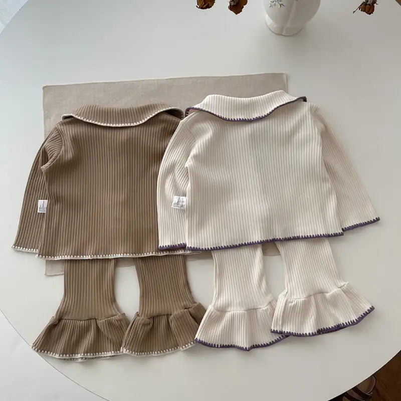 Chic Charm two-piece baby set with ruffles, made from 100% cotton, featuring a button closure and delicate ruffle details on sleeves and hem. Comfortable and stylish baby clothes for everyday wear or special occasions.