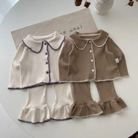 Chic Charm two-piece baby set with ruffles, made from 100% cotton, featuring a button closure and delicate ruffle details on sleeves and hem. Comfortable and stylish baby clothes for everyday wear or special occasions.