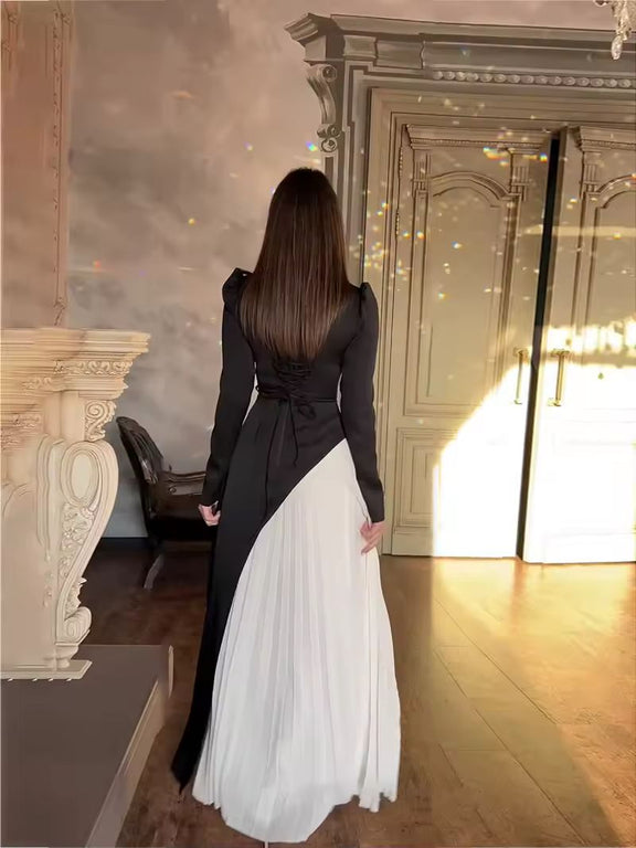 Elegant black and white long sleeve maxi dress for women, pleated panel detail, Warda Dress front view.
