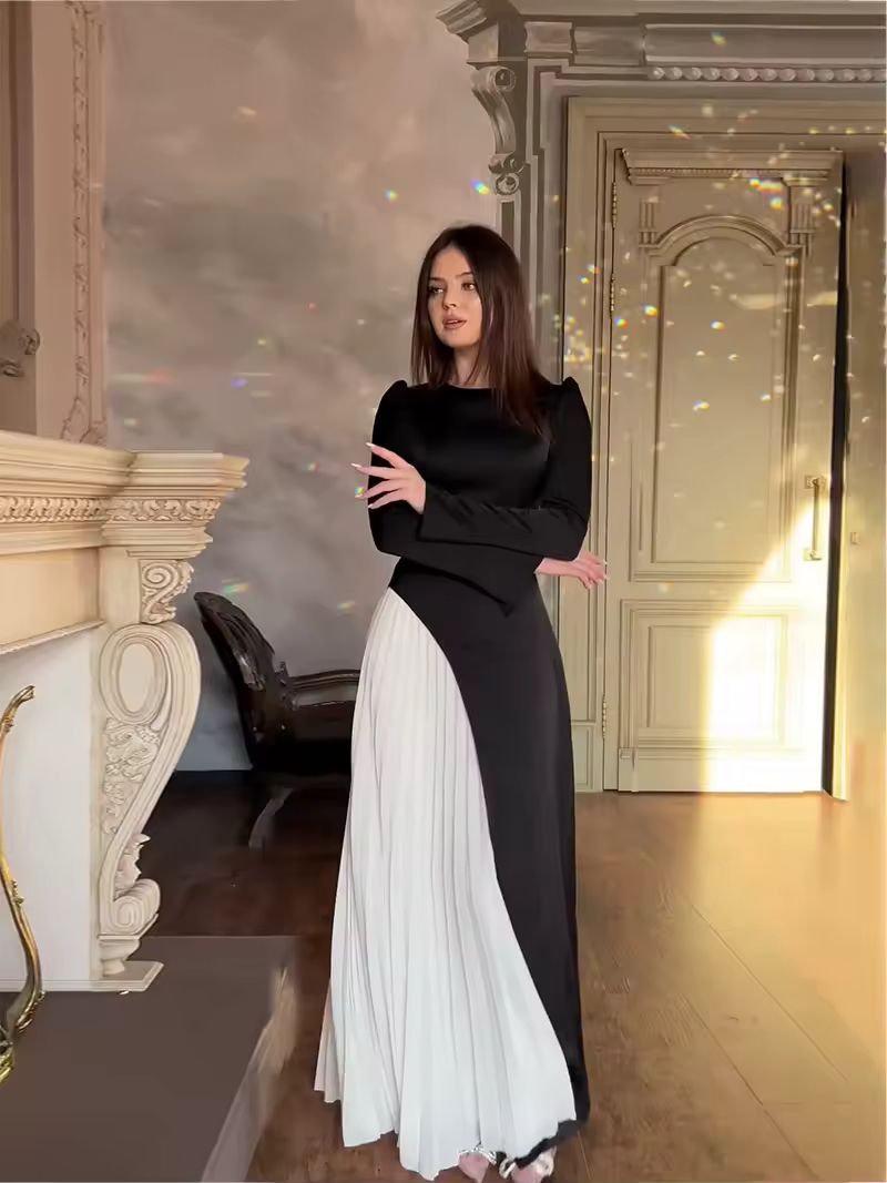 Luxury black evening dress with white flowing pleats, modern design inspired by couture aesthetics