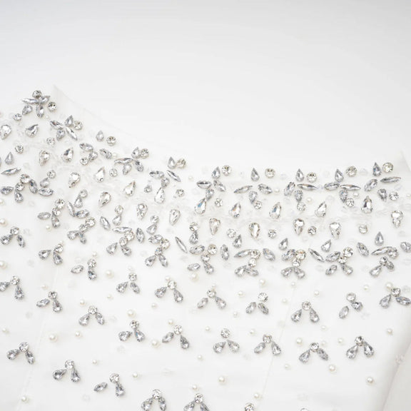 Close-up detail of pearls and crystals on Éclat de Lune black hand-embellished dress”