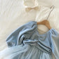 Elegant blue girls’ dress with long sleeves, elastic waist, ruffled skirt, and soft polyester fabric – perfect for comfort and style.