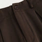 Side view of the elegant high-waisted trousers highlighting the wide-cut design and functional pockets.
