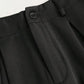 Elegant high-waisted trousers in black with a wide-cut oversized fit and functional pockets.