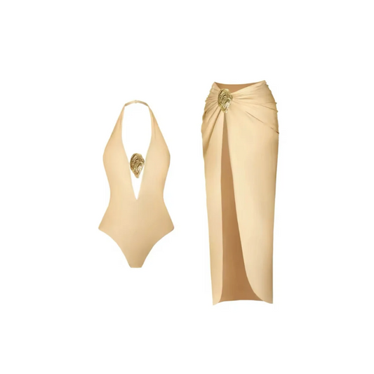 Elegant two-piece women’s summer set featuring a black or beige halterneck one-piece swimsuit with gold sculptural front detail, paired with a matching high-slit wrap skirt. Luxury swimwear set made from stretchy, quick-drying spandex-polyester blend. Feminine, minimalist beach outfit perfect for resort, vacation, or beach-to-dinner transitions. Available in black and beige with golden accents.
