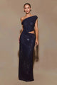 Elegant navy evening gown with asymmetrical neckline and diamond-style sequins, photographed under cool blue lighting.
