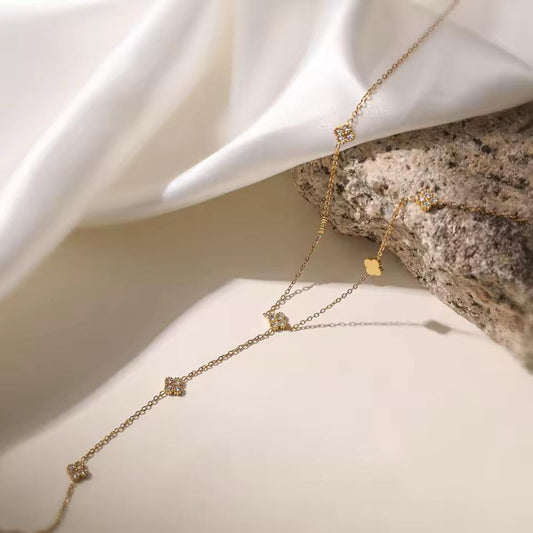 Delicate gold drop necklace with small crystal charms — elegant minimalist jewelry for everyday wear.