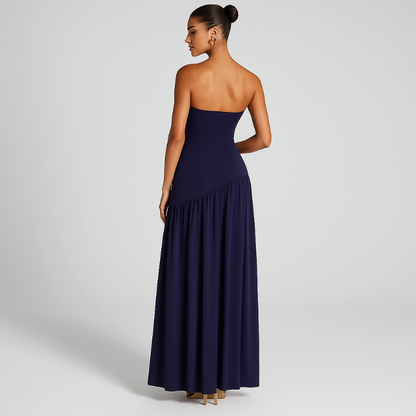 Model wearing the VICKY elegant strapless maxi dress in midnight blue with front slit and choker scarf.
