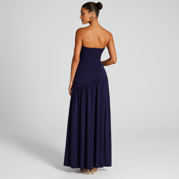 Model wearing the VICKY elegant strapless maxi dress in midnight blue with front slit and choker scarf.
