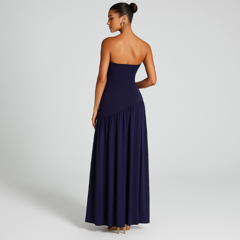Model wearing the VICKY elegant strapless maxi dress in midnight blue with front slit and choker scarf.
